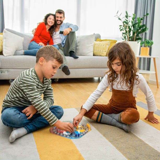 istock Cheerful children playing board games. 1286013264