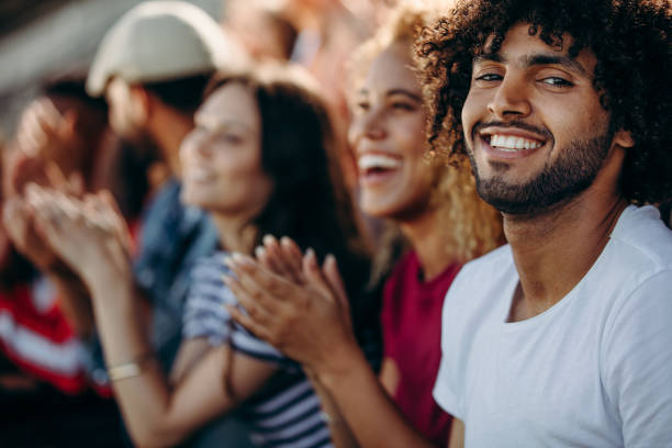 istock Man with friends watching a soccer match at stadium 1286013993
