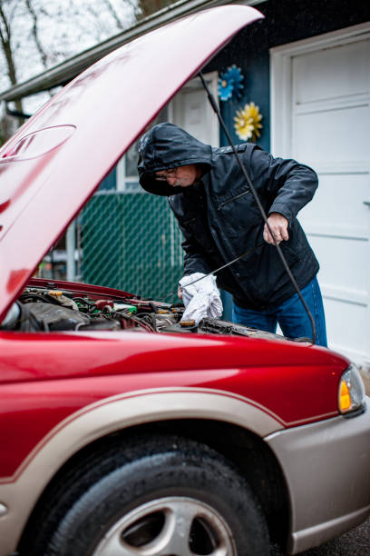 istock Man Checking The Oil In Car Engine 1286014264