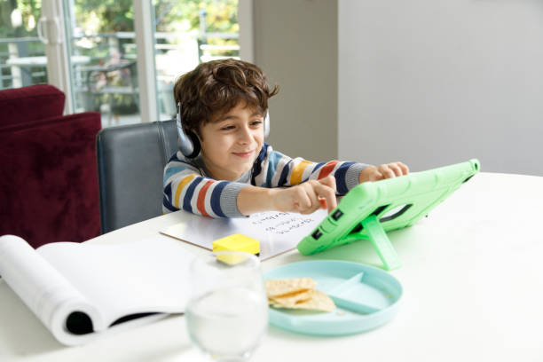 istock Virtual Schooling From Home with Six Year Old Boy 1286014586
