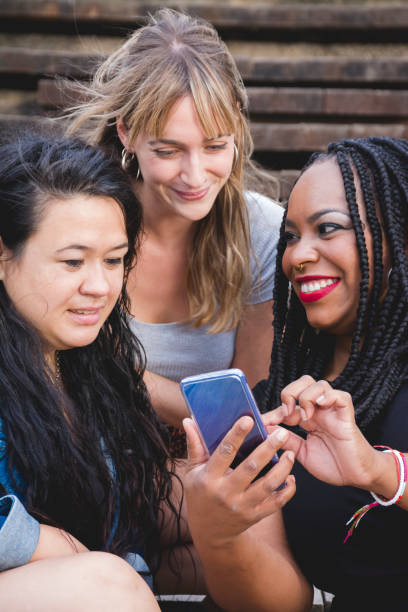 istock Three girls having fun with mobile phone 1286015221