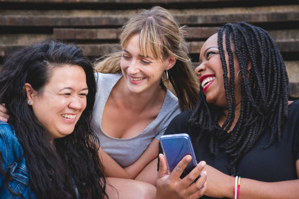 istock Three girls having fun with mobile phone 1286015275