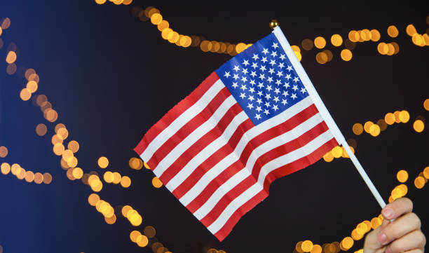istock USA flag, red white and blue with sparkling yellow bokeh background, Copy space, space for text. colorful design American concept 1286015803
