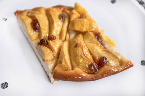 istock Apple tart with raisins on a white porcelain plate with an Art Deco pattern 1286016522