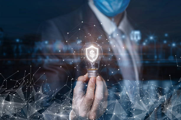 istock Businessman shows a light bulb with a burning shield and a dollar inside . 1286016599
