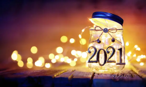 Happy New Year - Bokeh Lights And 2021 Metal Numbers In  Decorative Jar - Defocused Background