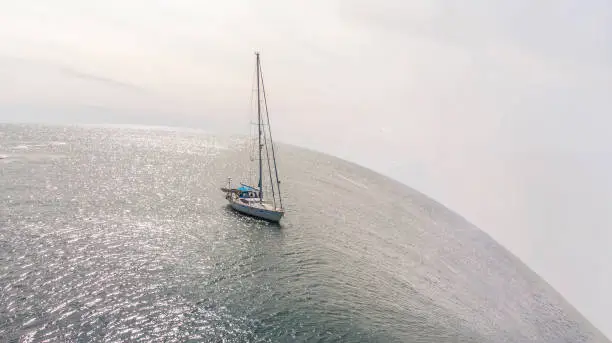 Photo of Sailboat about to go over a drop off in the ocean