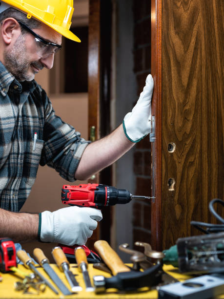 istock Carpenter at work repairs and installs the door lock. Carpentry. 1286017156