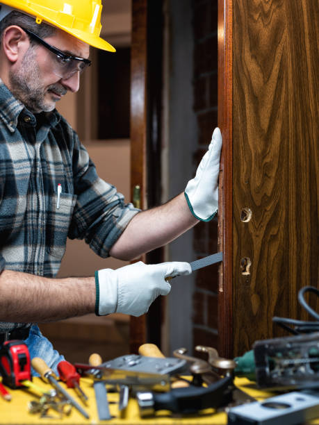 istock Carpenter at work repairs and installs the door lock. Carpentry. 1286017164