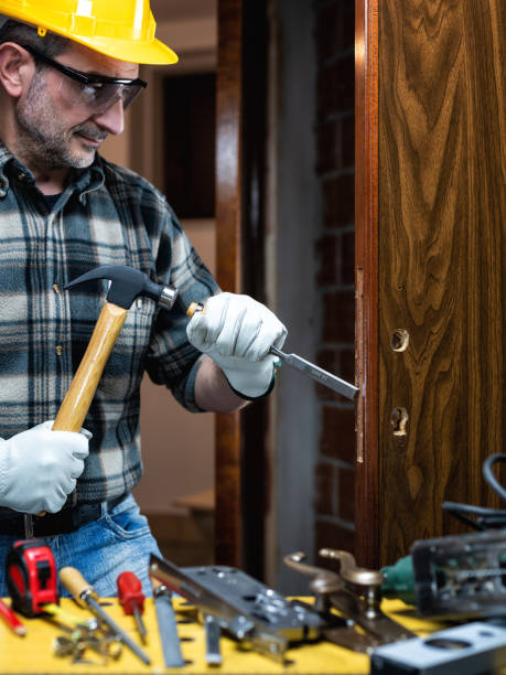 istock Carpenter at work repairs and installs the door lock. Carpentry. 1286017165