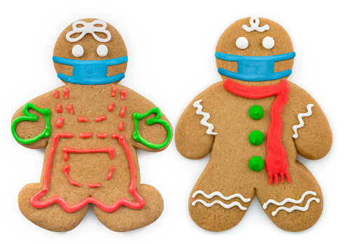 Gingerbread man and woman wearing a face mask. \nCoronavirus / COVID-19 theme. \nIsolated on a white background.