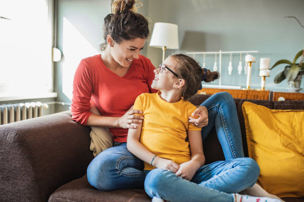 istock Mother and daughter embracing at home 1286017922