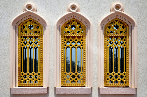 Beautiful golden windows of monument in the Muscat city