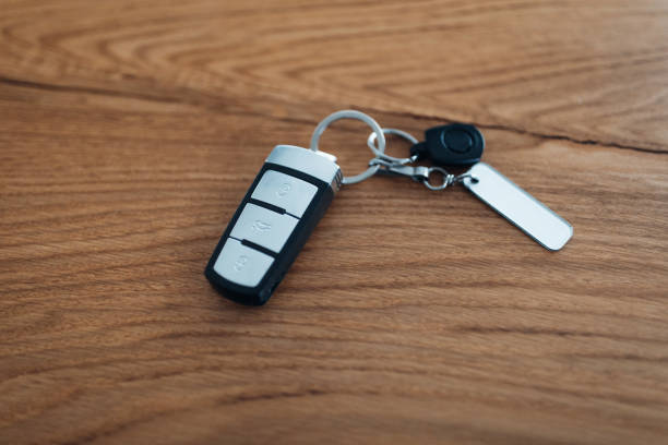 Car ignition key at the table Car ignition key at the table car keys table stock pictures, royalty-free photos & images