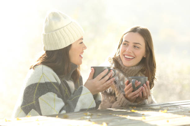 istock Happy friends talking at breakfast in winter 1286022475