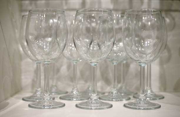 istock Several transparent glasses on a white shelf 1286022516