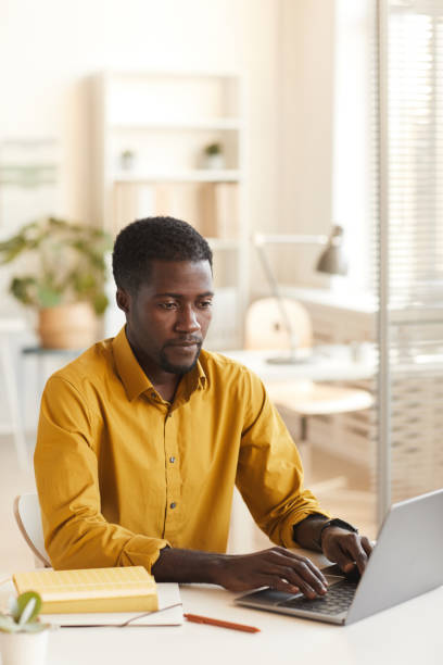 istock African-American Man Using Laptop in Office 1286022861