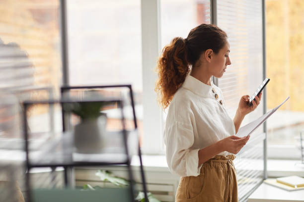 istock Successful Businesswoman Looking at Smartphone Screen 1286023715