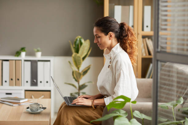 istock Successful Businesswoman Using Laptop at Home Side View 1286023812