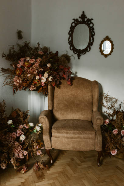 istock Brown armchair in studio room with flowers 1286025055