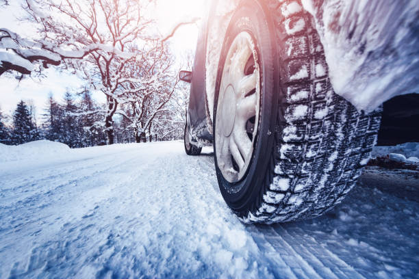 istock Car tires on winter road covered with snow 1286025056