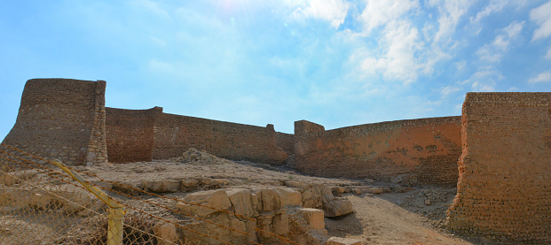 Tarout Island, Al Qatif county, Dammam, Eastern Province, Saudi Arabia: 16th century Portuguese fortress built on the island's tallest hill, over a Phoenician temple, that was dedicated to Astarte and several other previous settlements, dating back to 5000 BC. Eastern side of the castle, where one tower was destroyed, in the foreground the stone of the Phoenician temple over which the castle was built. Fortress built with sea mud, gypsum, and stone, located in the Deira neighborhood, Tarut Hill.