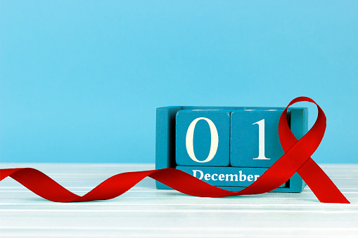 calendar December 1 red ribbon symbol of AIDS awareness. Concept for World AIDS Day. Anorexia problem. Vasculitis problem, copy spaсe