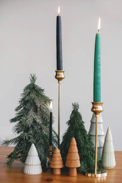 istock Christmas trees, candles and pine cones on rustic table. Festive modern zero waste decor 1286027143