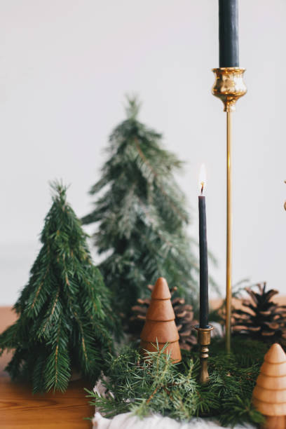 istock Modern Christmas table setting, miniature christmas trees, candles and pine cone decorations 1286027269