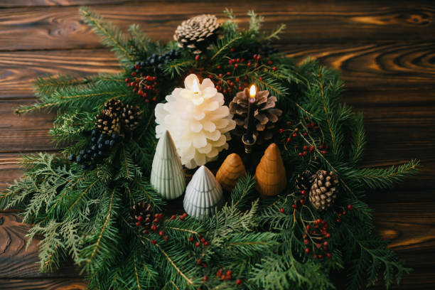 istock Merry Christmas! Modern wreath, trees, candles and pine cones on rustic  table, christmas table 1286027323