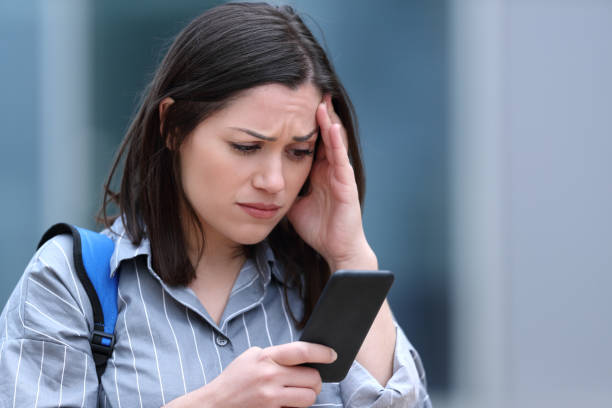 istock Worried student checks smart phone message 1286027394