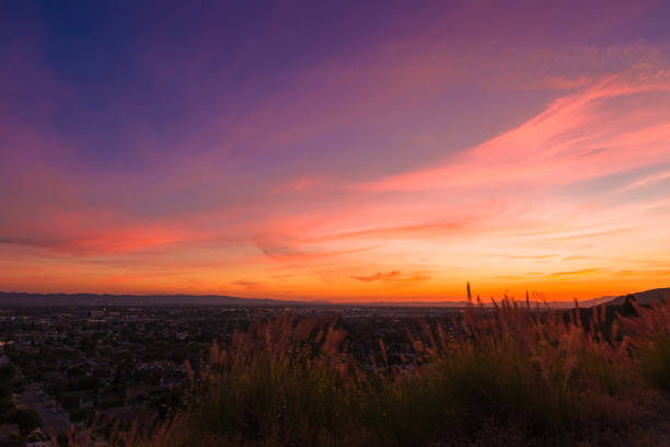 istock Sunset behind a fence looking over a mountain 1286027423