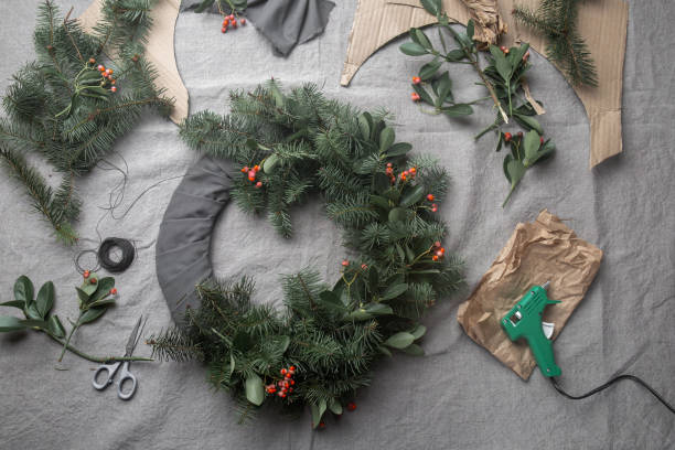 making christmas wreath. new year holiday decoration - gift orange green package imagens e fotografias de stock