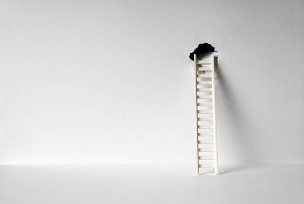 istock Ladder leaning against the hole in a wall. Escape or exit concept. Background with copy space. 1286030599