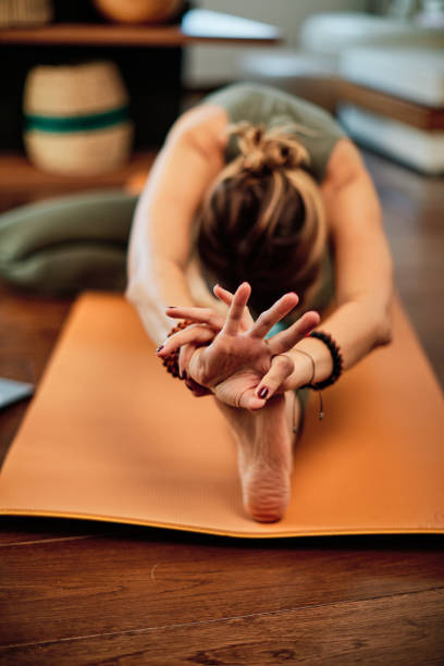 istock Flexible middle-aged yogi woman practicing yoga at home. 1286032575