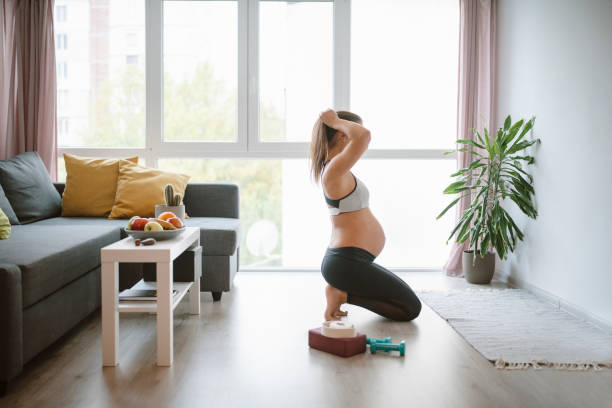 istock Pregnant woman practicing yoga at home. 1286035589
