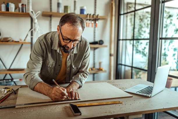 istock Mature handyman working on new diy project in home workshop 1286038968