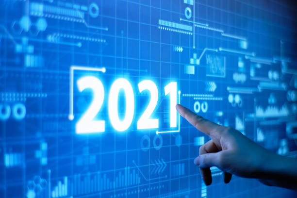 istock A hand presses on a futuristic 2021 year display. 1286039015