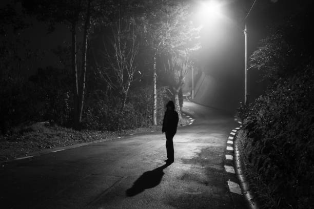 istock Photograph of an apparition on an empty road at night 1286041522
