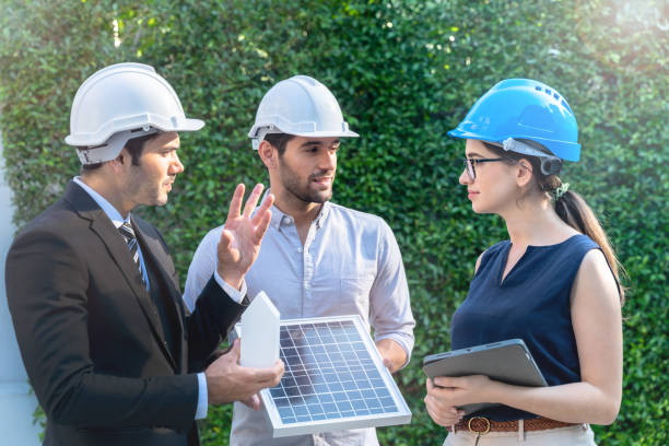 istock Business Engineers Meeting Innovative More Efficient Solar Panel Battery Concept of Renewable Energy Working. Specialists Gathered for Outdoor testing Photovoltaic cells module. 1286041602