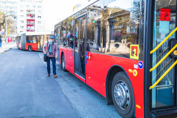 istock Handsome smiling senior man getting into bus. 1286042360