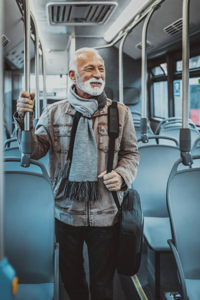 istock Senior man taking bus to work. Urban public transportation concept 1286042393
