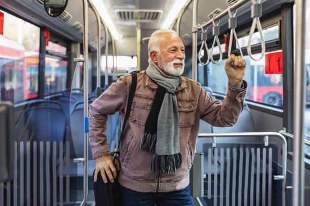 istock Senior man taking bus to work. Urban public transportation concept 1286042403