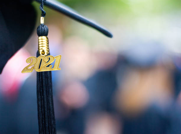 Class of 2021 Graduation Ceremony Tassel Black Closeup of a 2021 Graduation Tassel at a graduation ceremony. mortarboard photos stock pictures, royalty-free photos & images