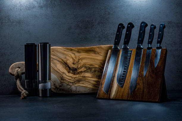 istock Kitchen knives, pepper and salt grinders + wooden cutting board 1286044477