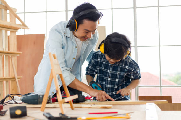 istock Asian father and son work in carpentry at home. 1286047657