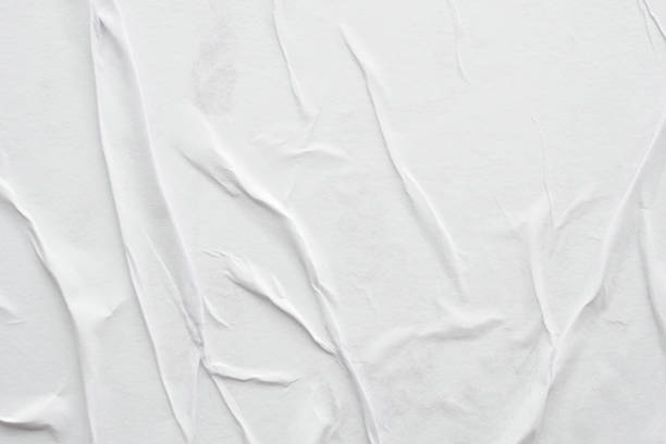 istock Blank white crumpled and creased paper poster texture background 1286048364