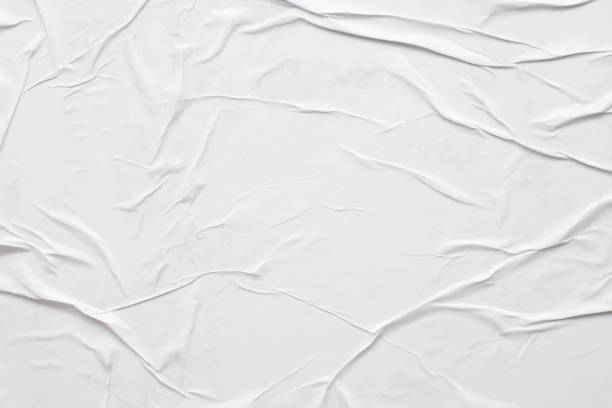 istock Blank white crumpled and creased paper poster texture background 1286048367