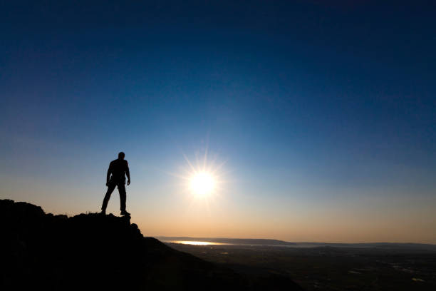 istock Traveler with a backpack standing on a mountain peak 1286048473