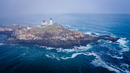 Aerial view of Nubble lighthouse in York, ME in fog